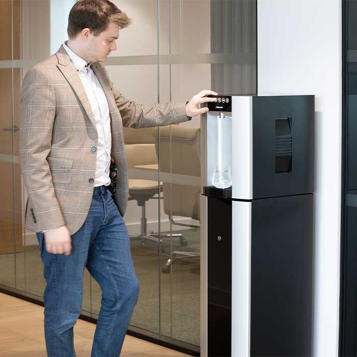 Man Using Mains-Fed Water Dispenser